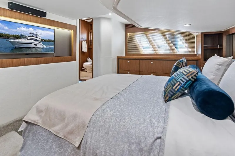 Slide: The Image of Luxurious 2017 Sea Ray Fly 510 yacht bedroom with modern decor and large TV. - 32