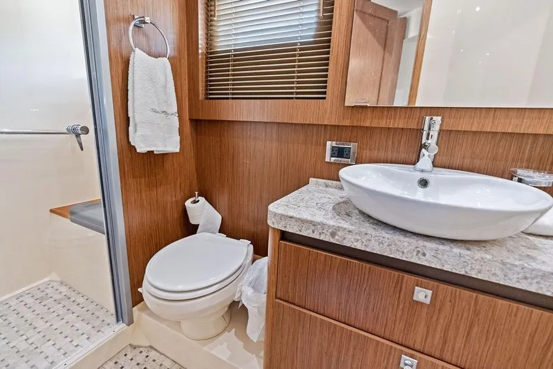 Slide: The Image of Luxurious bathroom in 2017 Sea Ray Fly 510 yacht with modern fixtures and wood accents. - 34