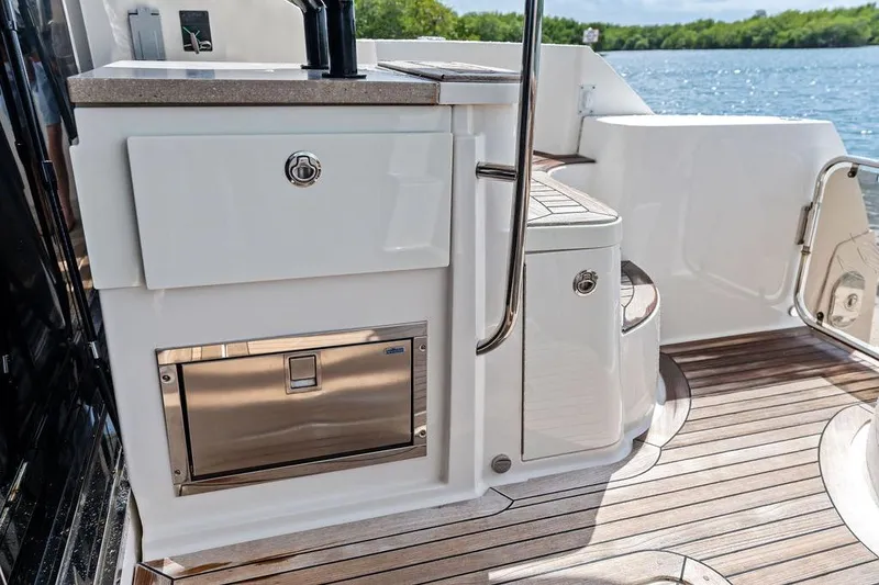 Slide: The Image of Luxurious 2017 Sea Ray Fly 510 yacht deck with sleek cabinetry and scenic water view. - 36