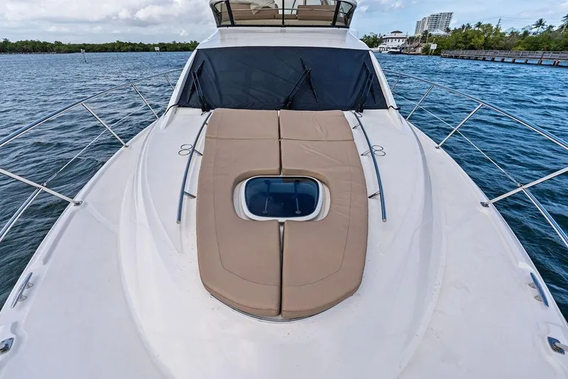 Slide: The Image of 2017 Sea Ray Fly 510 yacht with sunpad on deck, cruising on calm waters. - 41