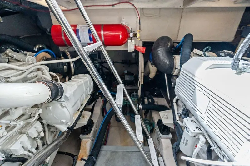 Slide: The Image of Engine room of 2017 Sea Ray Fly 510 yacht with visible machinery and fire extinguisher. - 48