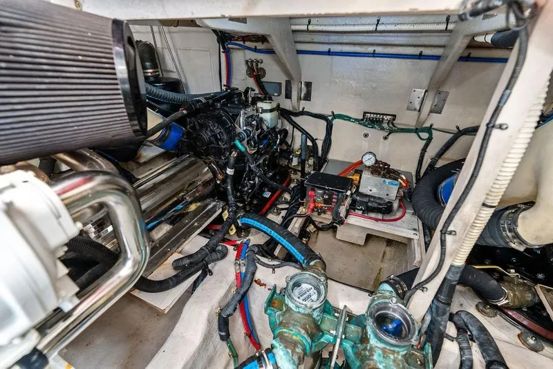Slide: The Image of Engine room of a 2017 Sea Ray Fly 510 yacht, showcasing mechanical components and wiring. - 51