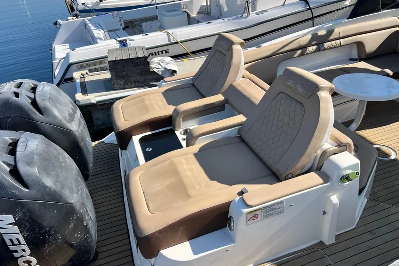 Slide: The Image of 2016 Sea Ray 290 Sundeck Outboard with beige seating and dual Mercury engines. - 10