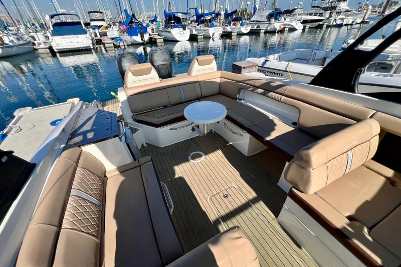 Slide: The Image of 2016 Sea Ray 290 Sundeck Outboard with spacious seating at a marina. - 15