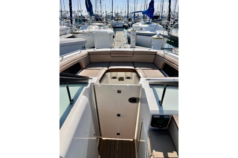 Slide: The Image of 2016 Sea Ray 290 Sundeck Outboard interior with spacious seating at marina. - 21