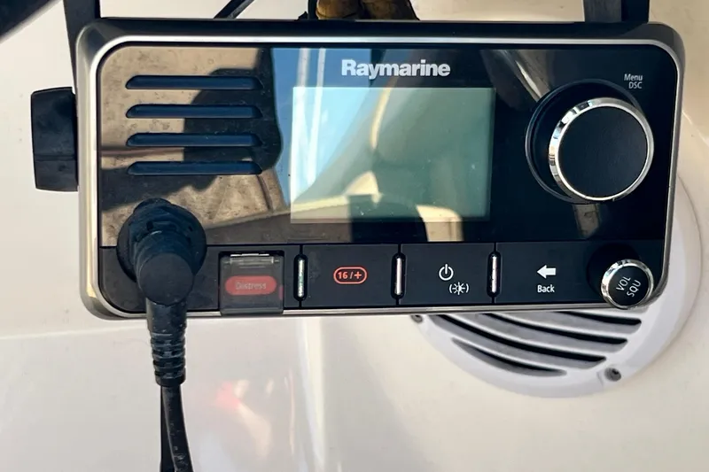 Slide: The Image of Raymarine marine radio on 2016 Sea Ray 290 Sundeck Outboard boat dashboard. - 32