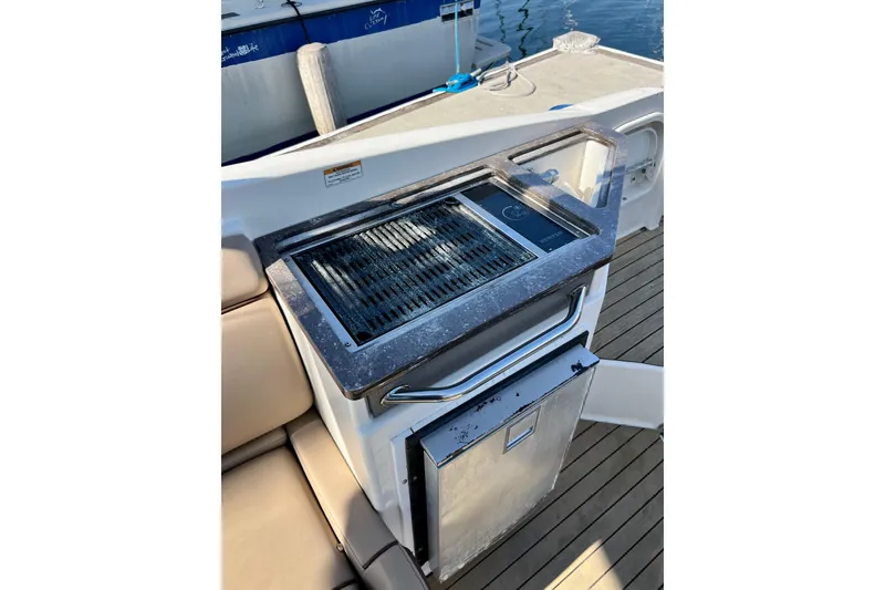 Slide: The Image of Outdoor grill and mini-fridge on 2016 Sea Ray 290 Sundeck Outboard boat deck. - 34