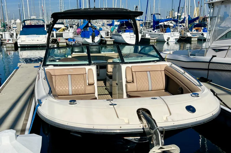 Slide: The Image of 2016 Sea Ray 290 Sundeck Outboard docked at a marina with sailboats. - 4