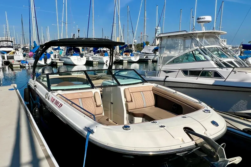Slide: The Image of 2016 Sea Ray 290 Sundeck Outboard docked at marina with sailboats in background. - 5