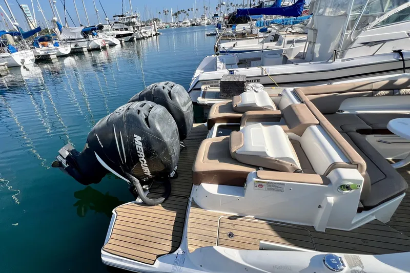 Slide: The Image of 2016 Sea Ray 290 Sundeck Outboard with twin Mercury engines docked at marina. - 9