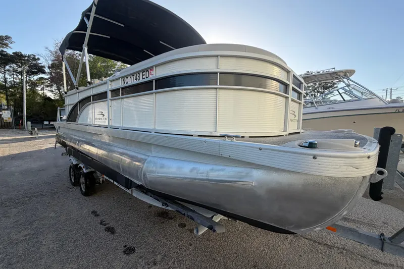 Slide: The Image of 2016 Bennington 22 SX pontoon boat with canopy, parked on a trailer. - 16