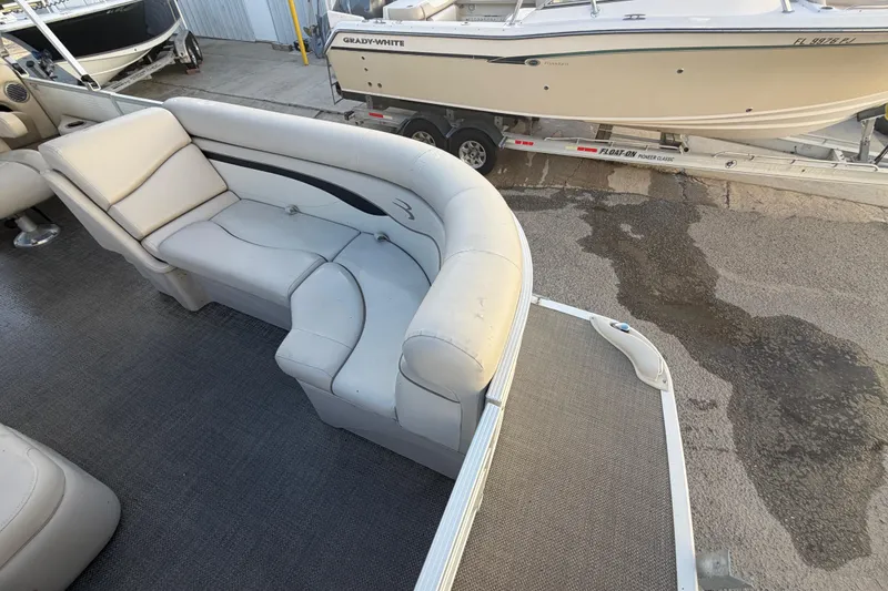 Slide: The Image of 2016 Bennington 22 SX pontoon boat interior with beige seating and carpeted flooring. - 32
