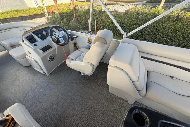 Slide: The Image of 2016 Bennington 22 SX boat interior with steering console and seating. - 45