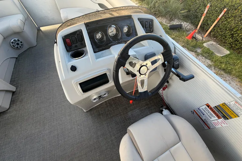 Slide: The Image of 2016 Bennington 22 SX boat dashboard with steering wheel and control panel. - 48
