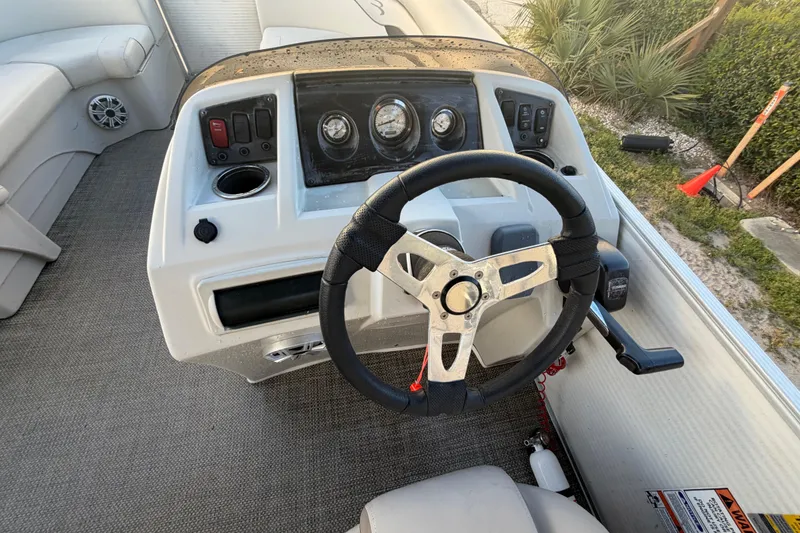 Slide: The Image of Steering console of a 2016 Bennington 22 SX pontoon boat with gauges and controls. - 49
