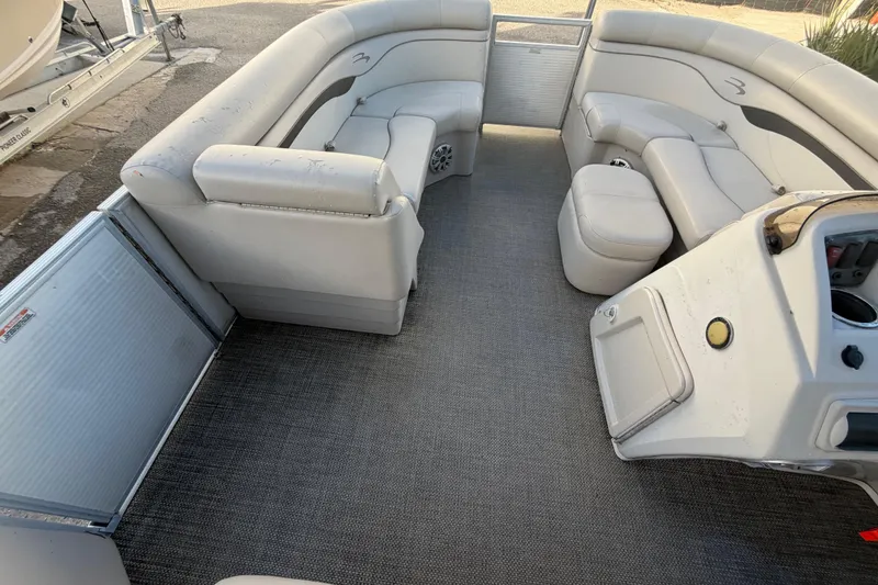 Slide: The Image of Interior of a 2016 Bennington 22 SX pontoon boat with spacious seating and helm. - 50