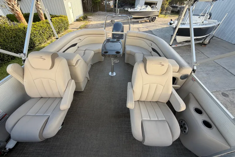 Slide: The Image of 2016 Bennington 22 SX pontoon boat interior with beige seating and helm. - 51