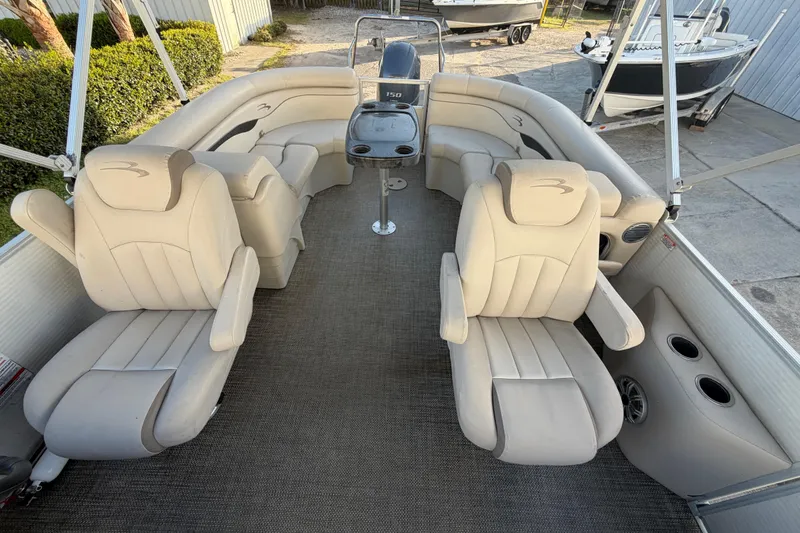 Slide: The Image of 2016 Bennington 22 SX pontoon boat interior with beige seating and steering console. - 52