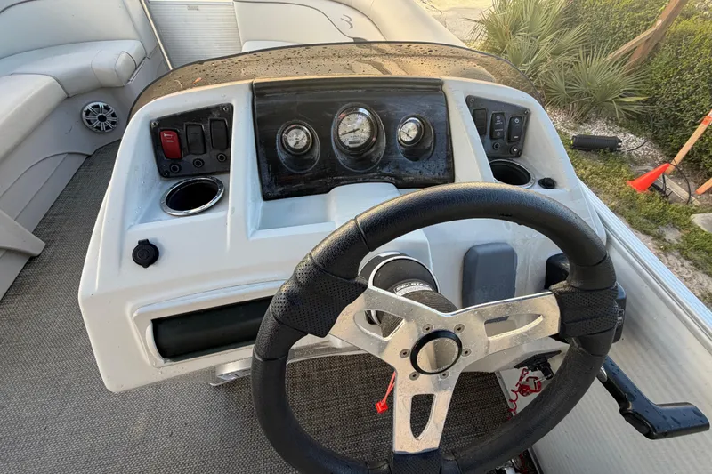 Slide: The Image of Steering console of a 2016 Bennington 22 SX boat with gauges and controls. - 57