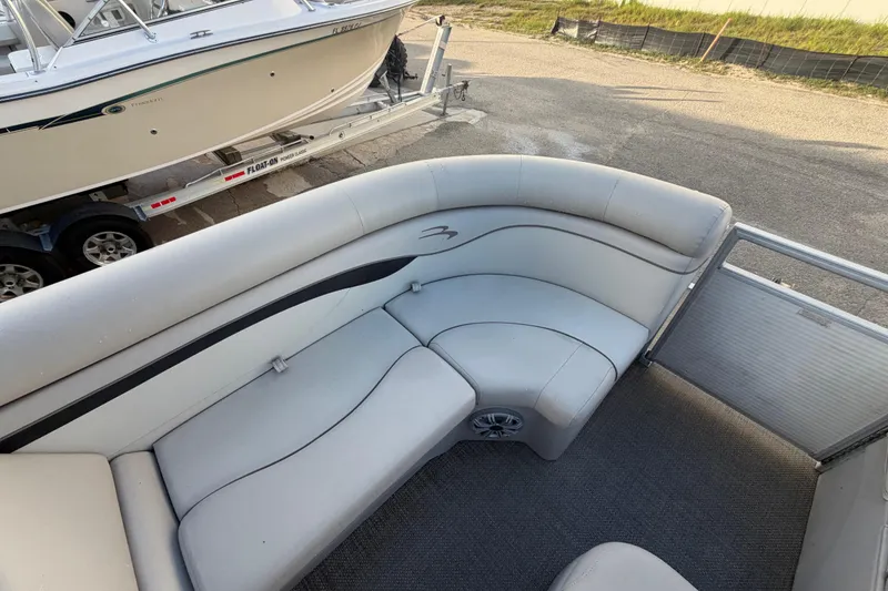 Slide: The Image of 2016 Bennington 22 SX boat interior with gray seating and carpeted floor. - 63