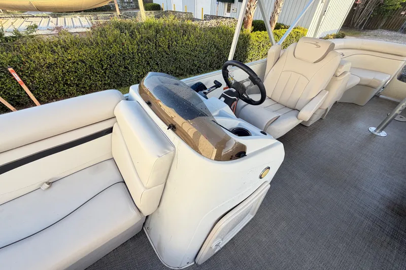 Slide: The Image of 2016 Bennington 22 SX boat interior with beige seating and steering console. - 64