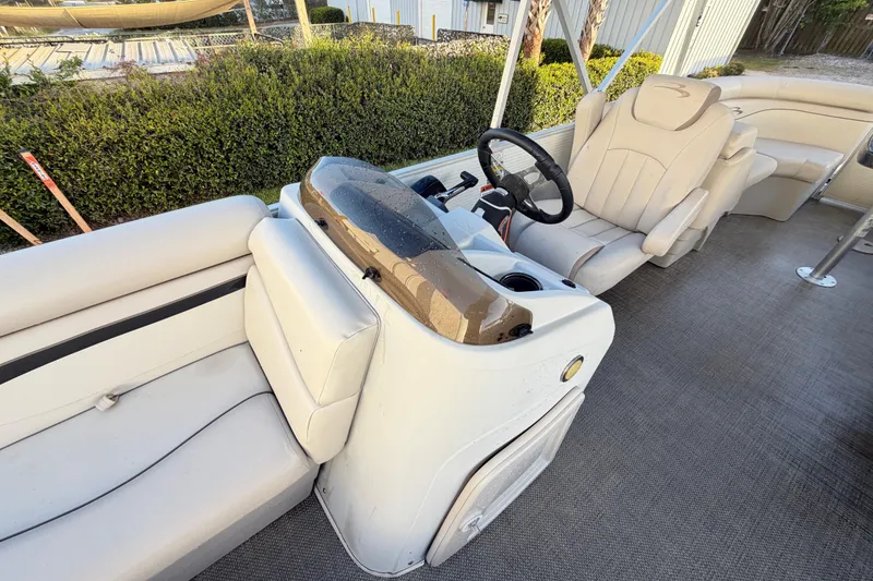 Slide: The Image of 2016 Bennington 22 SX boat interior with beige seating and steering console. - 65