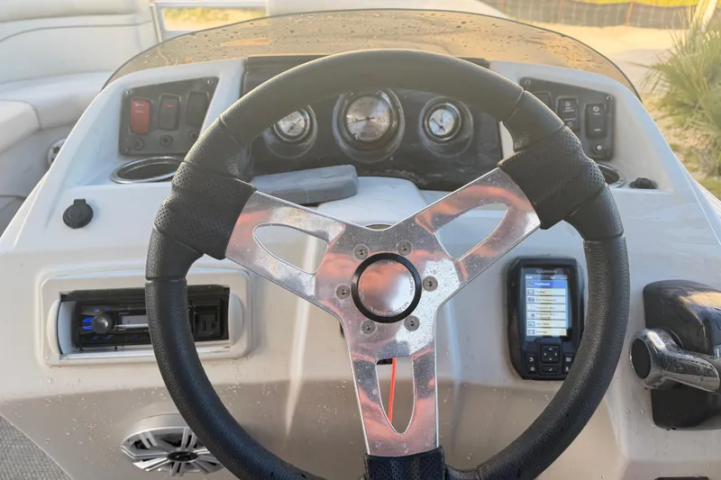 Slide: The Image of Steering console of a 2016 Bennington 22 SX boat with gauges and controls. - 67