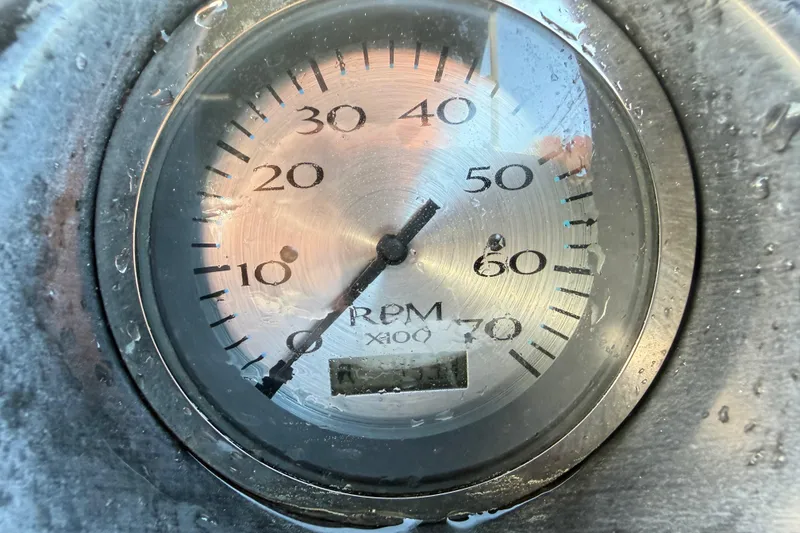 Slide: The Image of Close-up of a 2016 Bennington 22 SX RPM gauge, showing water droplets. - 69