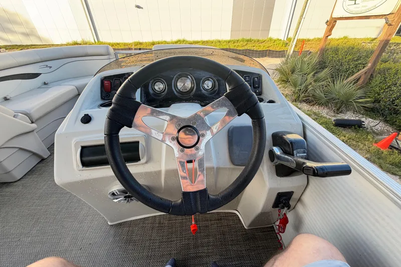 Slide: The Image of Steering console of a 2016 Bennington 22 SX pontoon boat with gauges and controls. - 73