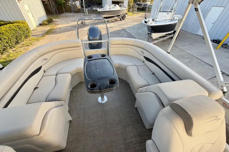 Slide: The Image of 2016 Bennington 22 SX pontoon boat with spacious seating and central table. - 75