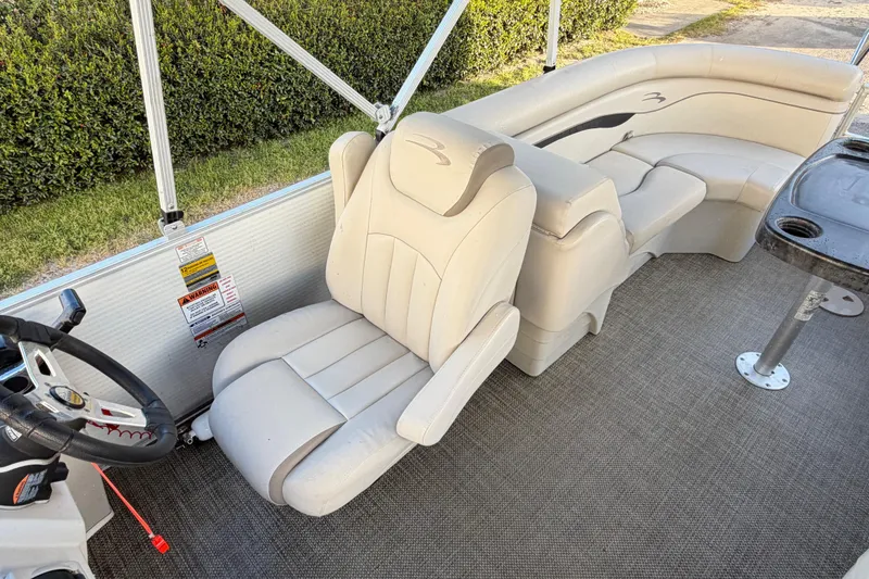 Slide: The Image of 2016 Bennington 22 SX boat interior with plush seating and steering wheel. - 79