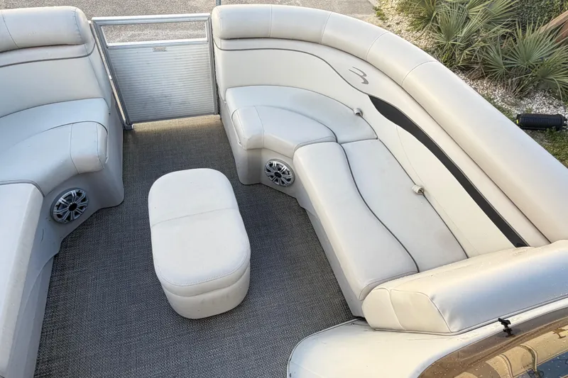 Slide: The Image of 2016 Bennington 22 SX pontoon boat interior with plush seating and speakers. - 81