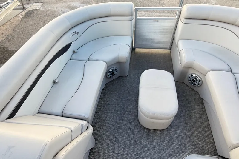 Slide: The Image of 2016 Bennington 22 SX pontoon boat interior with plush seating and speakers. - 82