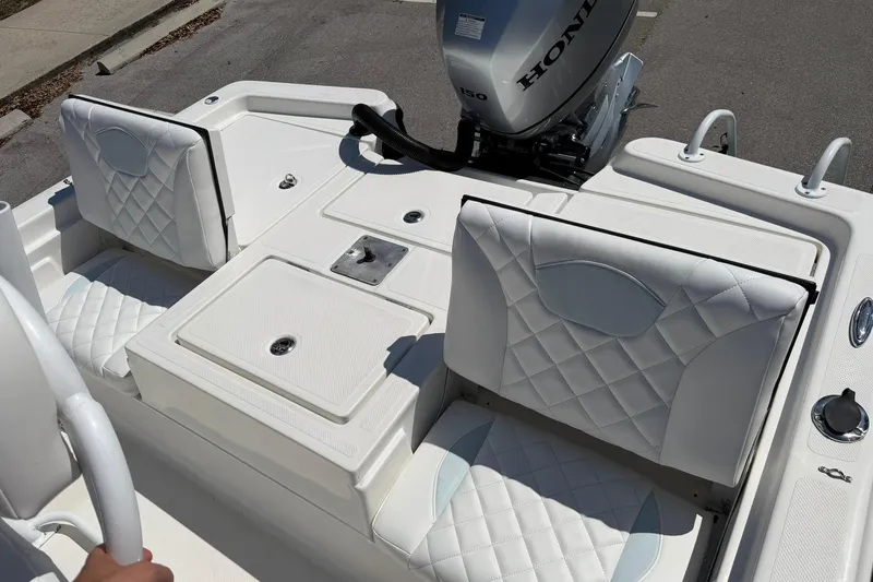 Slide: The Image of 2018 Epic 22SC boat interior with quilted seats and Honda outboard motor. - 12