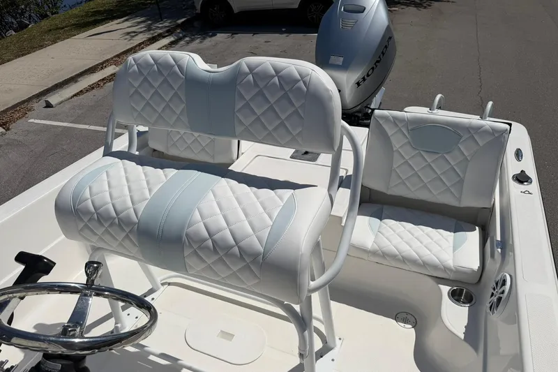 Slide: The Image of 2018 Epic 22SC boat interior with quilted white seats and Honda outboard motor. - 13