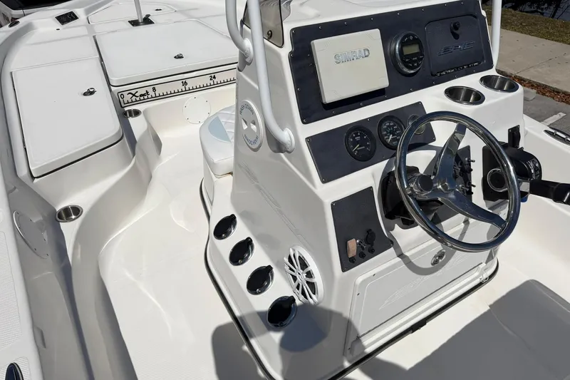 Slide: The Image of 2018 Epic 22SC boat interior with steering console and navigation equipment. - 16