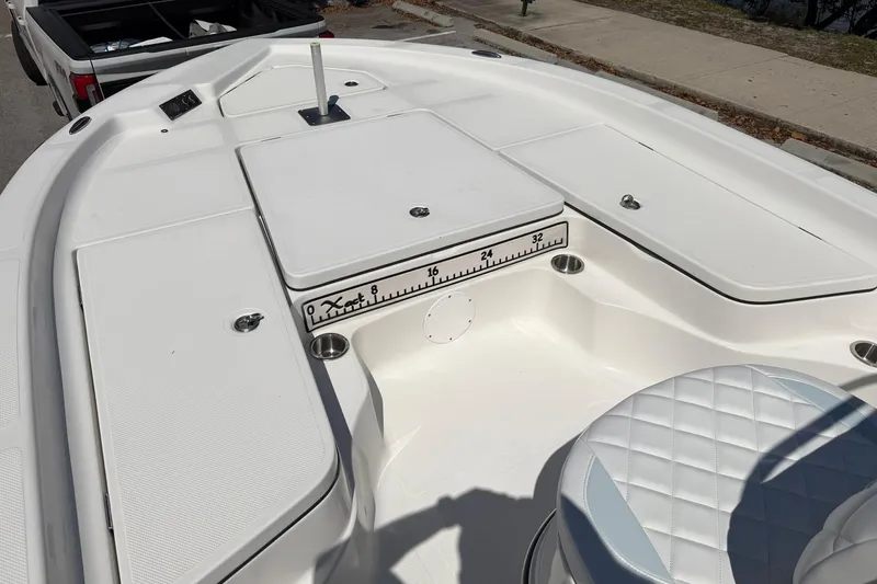 Slide: The Image of Bow area of a 2018 Epic 22SC boat with storage compartments and seating. - 17