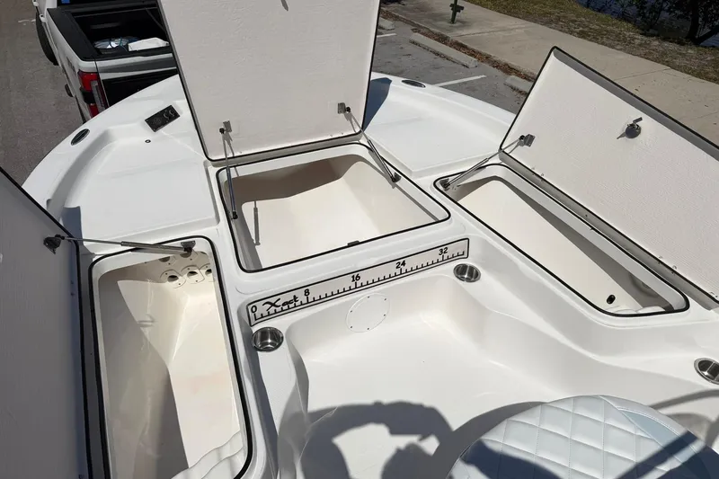 Slide: The Image of 2018 Epic 22SC boat storage compartments open, showcasing spacious interior design. - 18