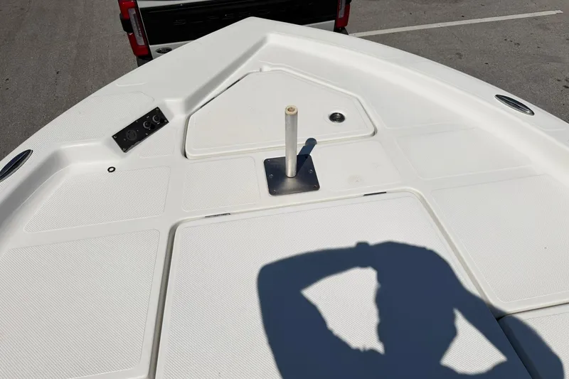 Slide: The Image of Bow of a 2018 Epic 22SC boat with a shadow and truck in background. - 19