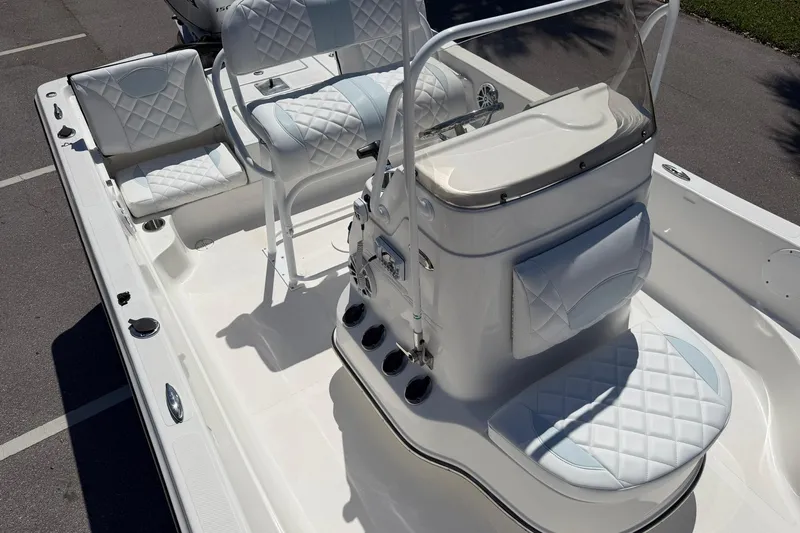 Slide: The Image of 2018 Epic 22SC boat interior with white quilted seating and console. - 21
