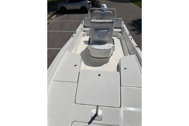 Slide: The Image of 2018 Epic 22SC boat deck with seating, parked in a lot. - 22