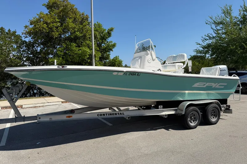 Slide: The Image of 2018 Epic 22SC boat on trailer, parked outdoors under clear blue sky. - 7