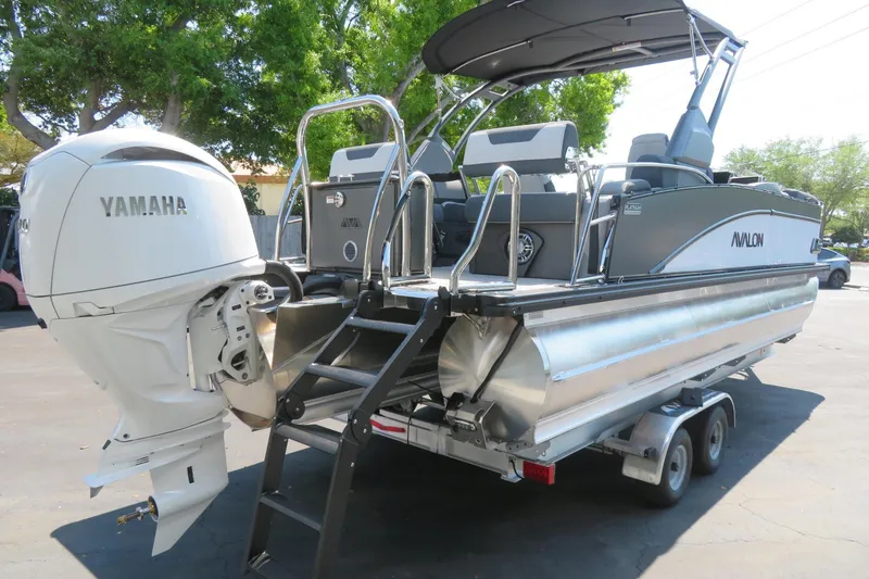 Slide: The Image of 2026 Avalon Catalina Quad Lounge Shift boat with Yamaha engine, parked on trailer. - 15