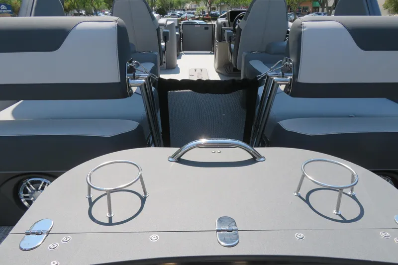 Slide: The Image of 2026 Avalon Catalina Quad Lounge boat interior with cup holders and seating. - 29