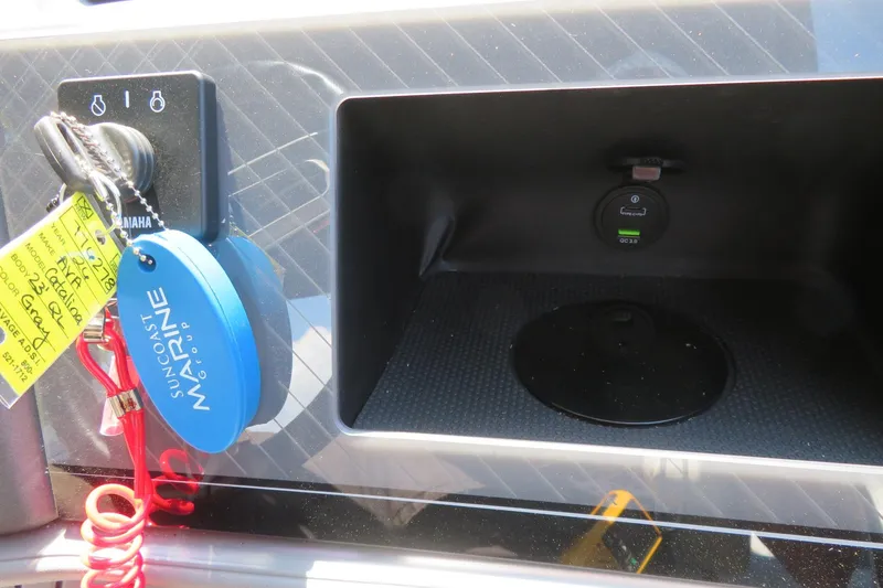 Slide: The Image of Dashboard of 2026 Avalon Catalina Quad Lounge Shift with keys and charging port. - 60