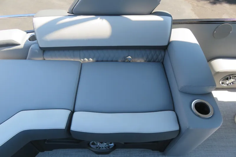 Slide: The Image of Luxurious seating on 2026 Avalon Catalina Quad Lounge Shift boat, featuring cup holders and premium upholstery. - 68