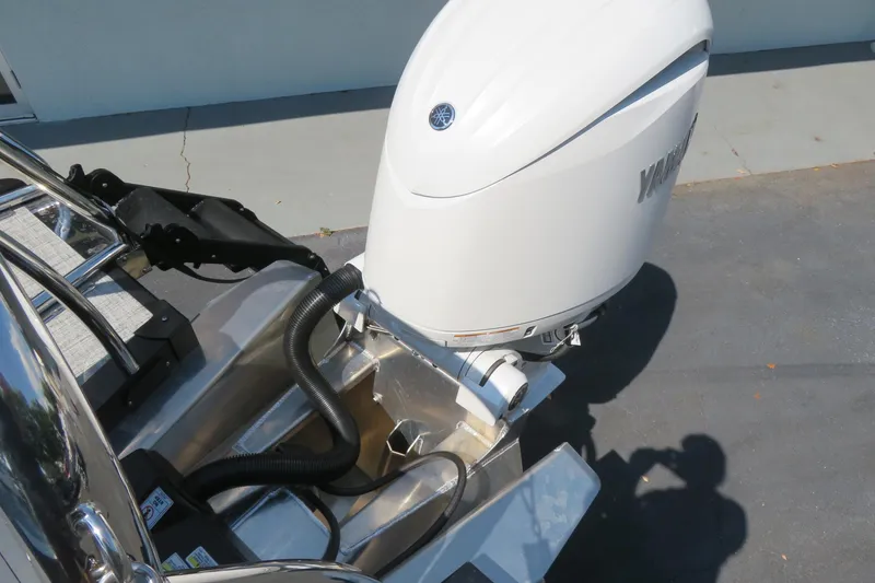 Slide: The Image of 2026 Avalon Catalina Quad Lounge Shift pontoon boat on trailer, parked outdoors. - 7