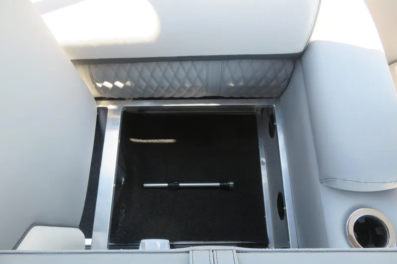 Slide: The Image of Avalon Catalina Quad Lounge 2026 storage compartment with sleek upholstery and cup holder. - 70