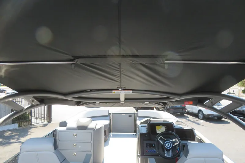 Slide: The Image of 2026 Avalon Catalina Quad Lounge Shift boat interior with steering wheel and seating. - 74