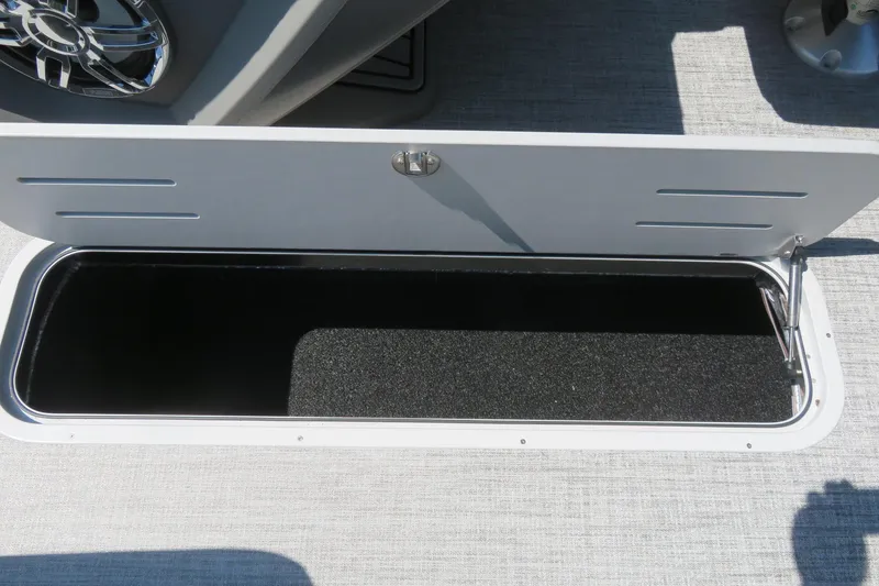 Slide: The Image of Open storage compartment on 2026 Avalon Catalina Quad Lounge Shift boat. - 76
